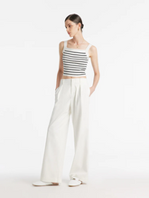 a lady in white wide leg full length jeans